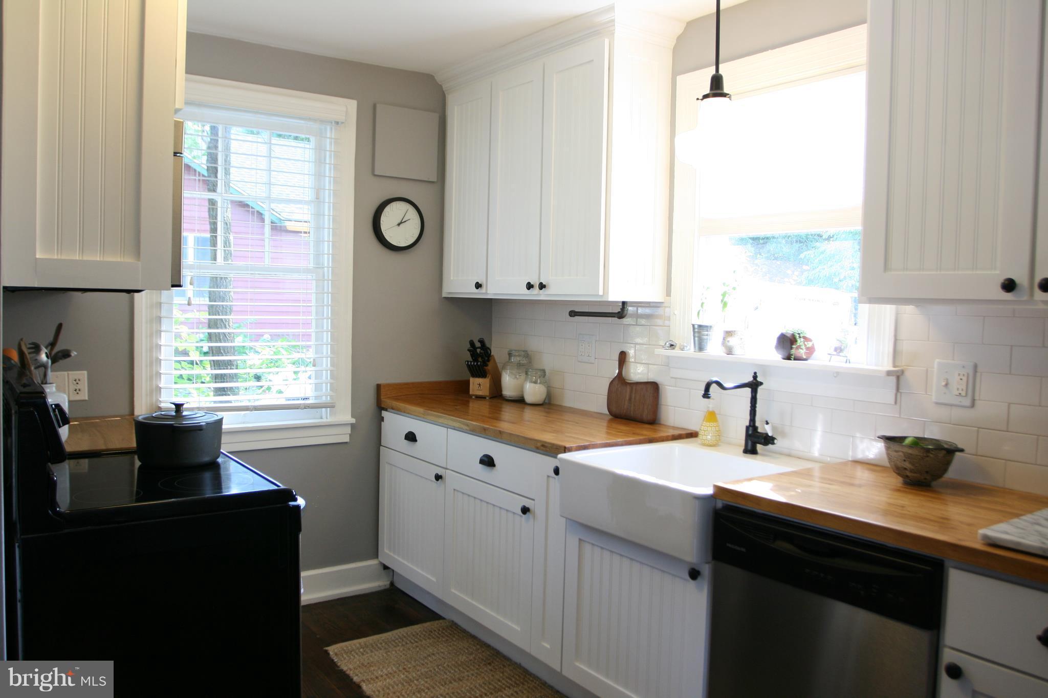 1804 Bay Ridge Avenue Annapolis, MD 21403 - Photo 13 of 26 a kitchen with stainless steel appliances granite countertop a sink a stove a refrigerator a counter space and window