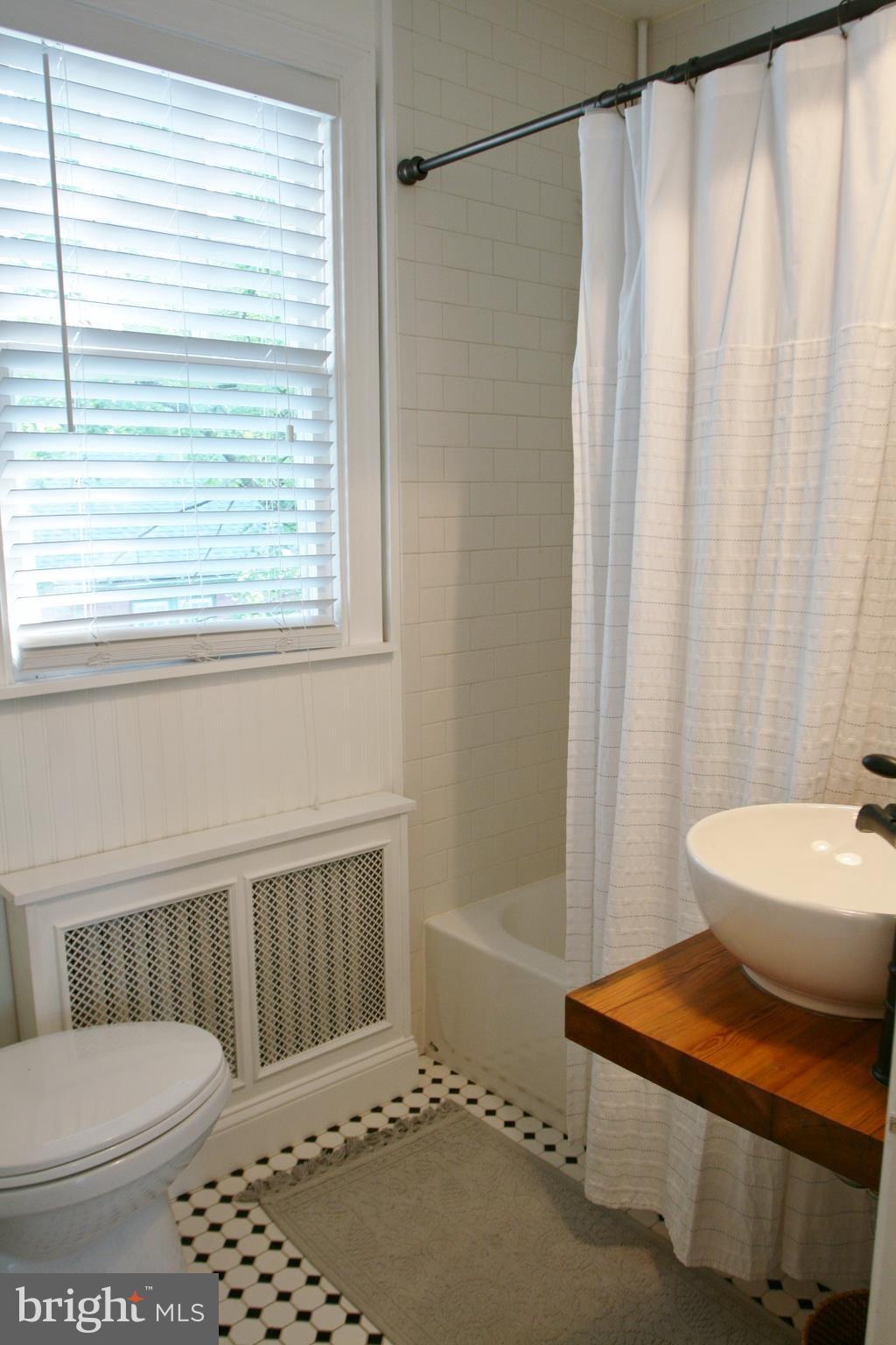 1804 Bay Ridge Avenue Annapolis, MD 21403 - Photo 17 of 26 a bathroom with a sink a toilet a window and shower