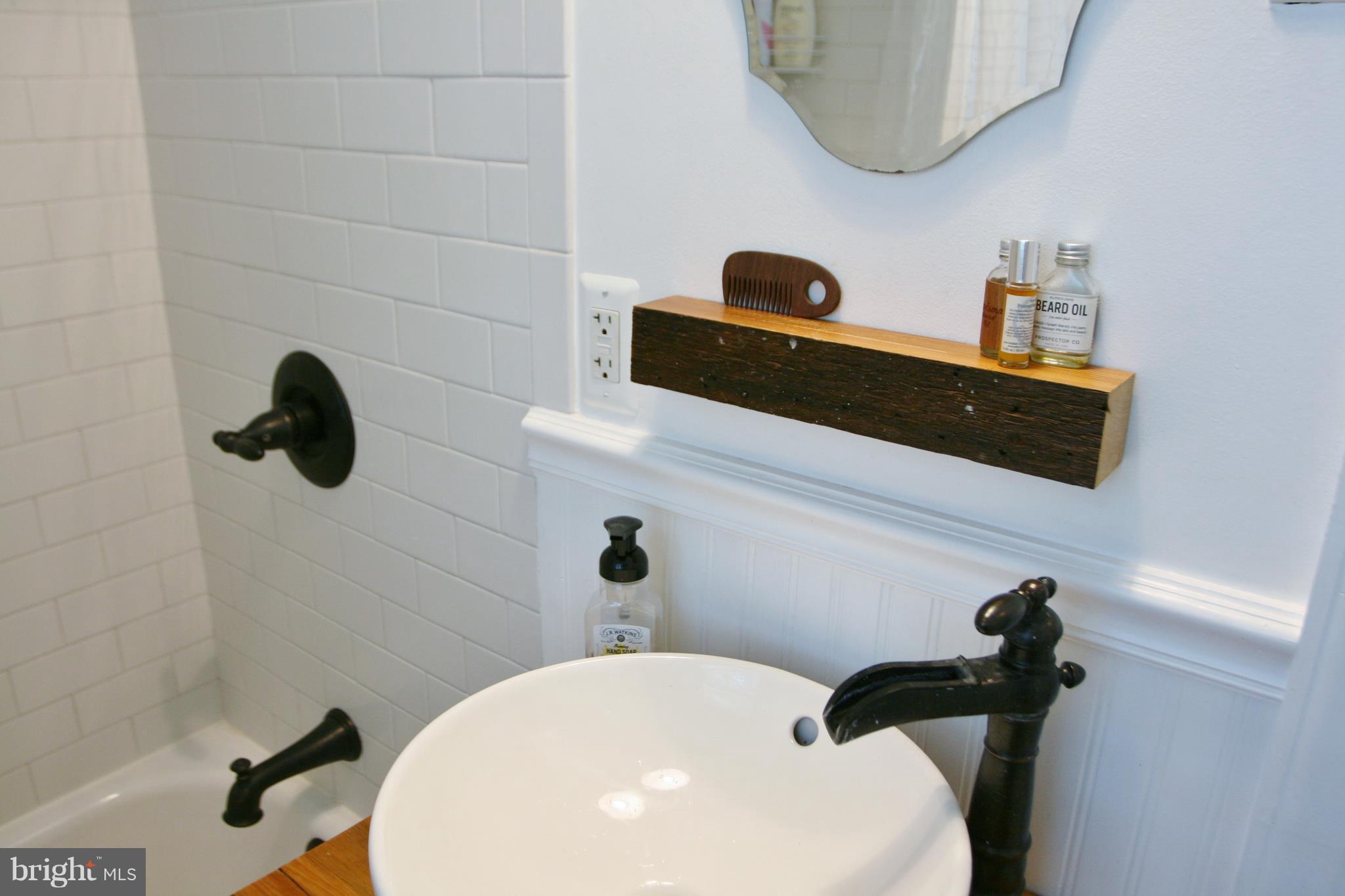 1804 Bay Ridge Avenue Annapolis, MD 21403 - Photo 18 of 26 a bathroom with a sink a toilet and shower