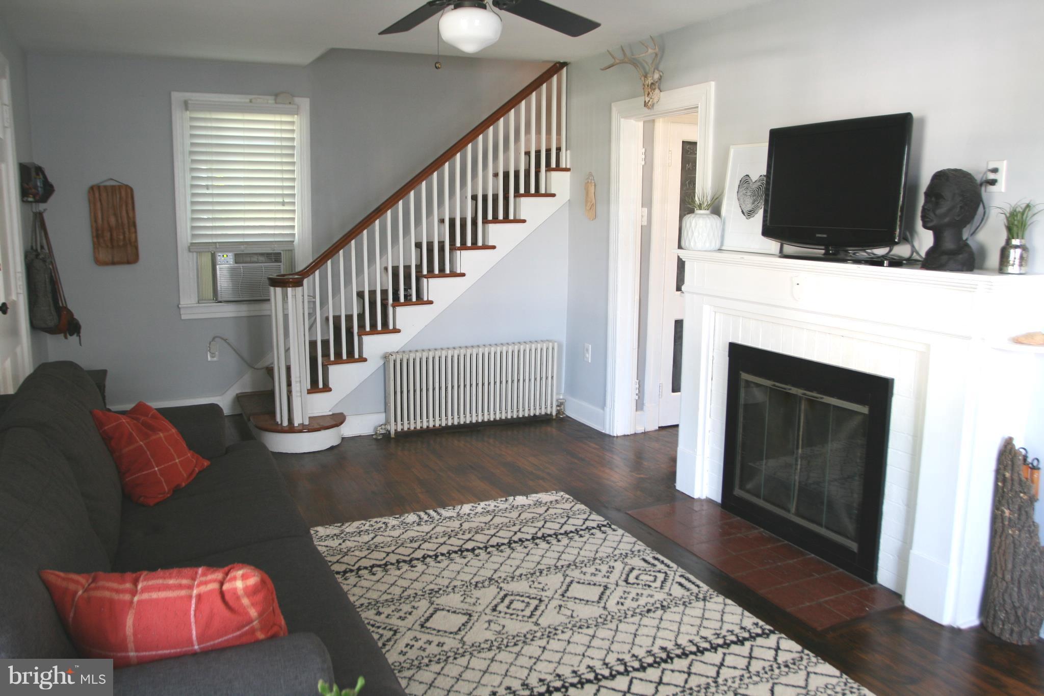 1804 Bay Ridge Avenue Annapolis, MD 21403 - Photo 8 of 26 a living room with furniture and a fireplace