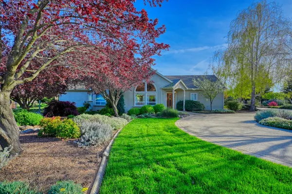 a view of a street with a house in the background