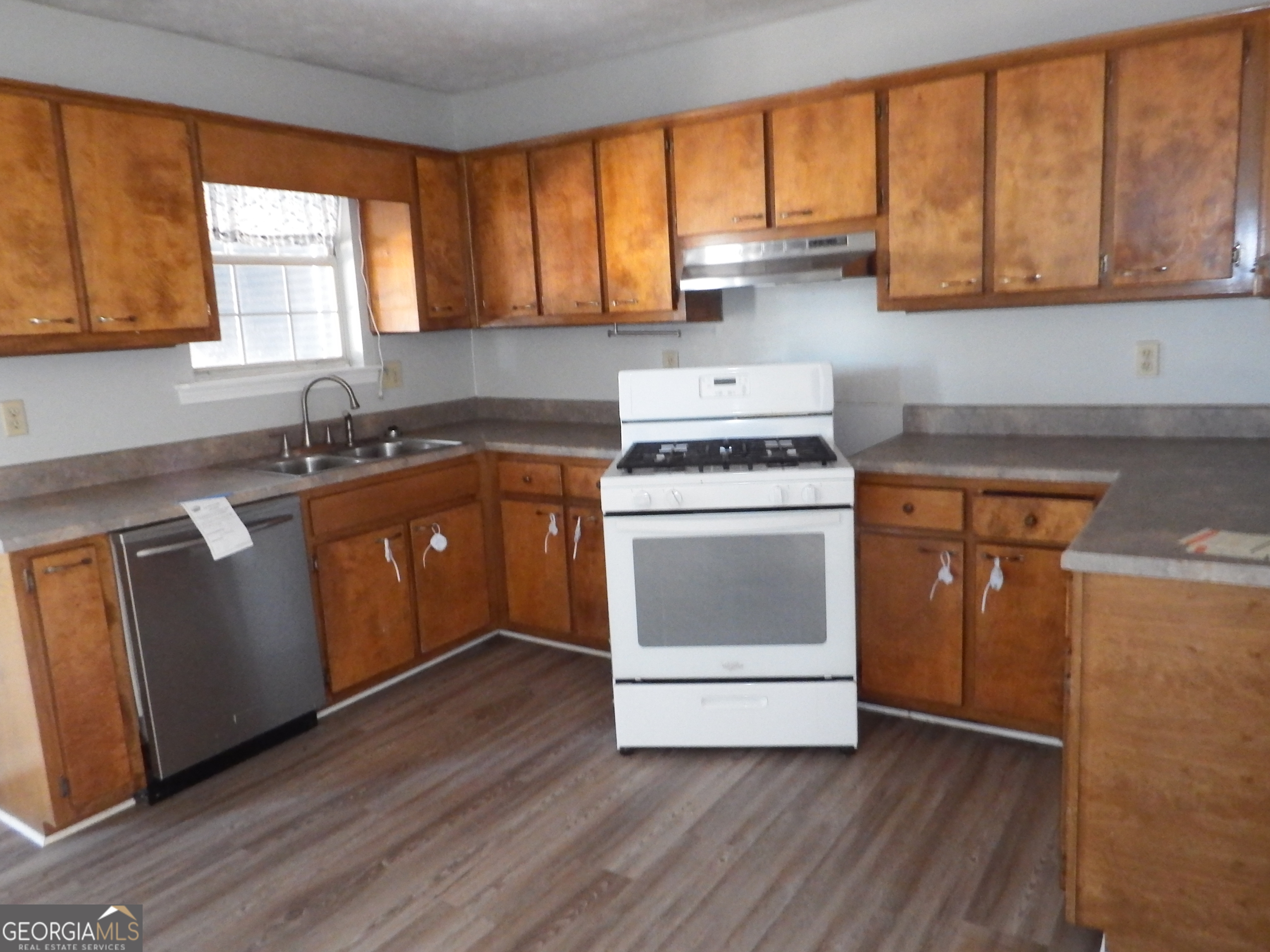 2780 Highpoint Road Snellville, GA 30078 - Photo 3 of 12 a kitchen with a stove a sink and a microwave