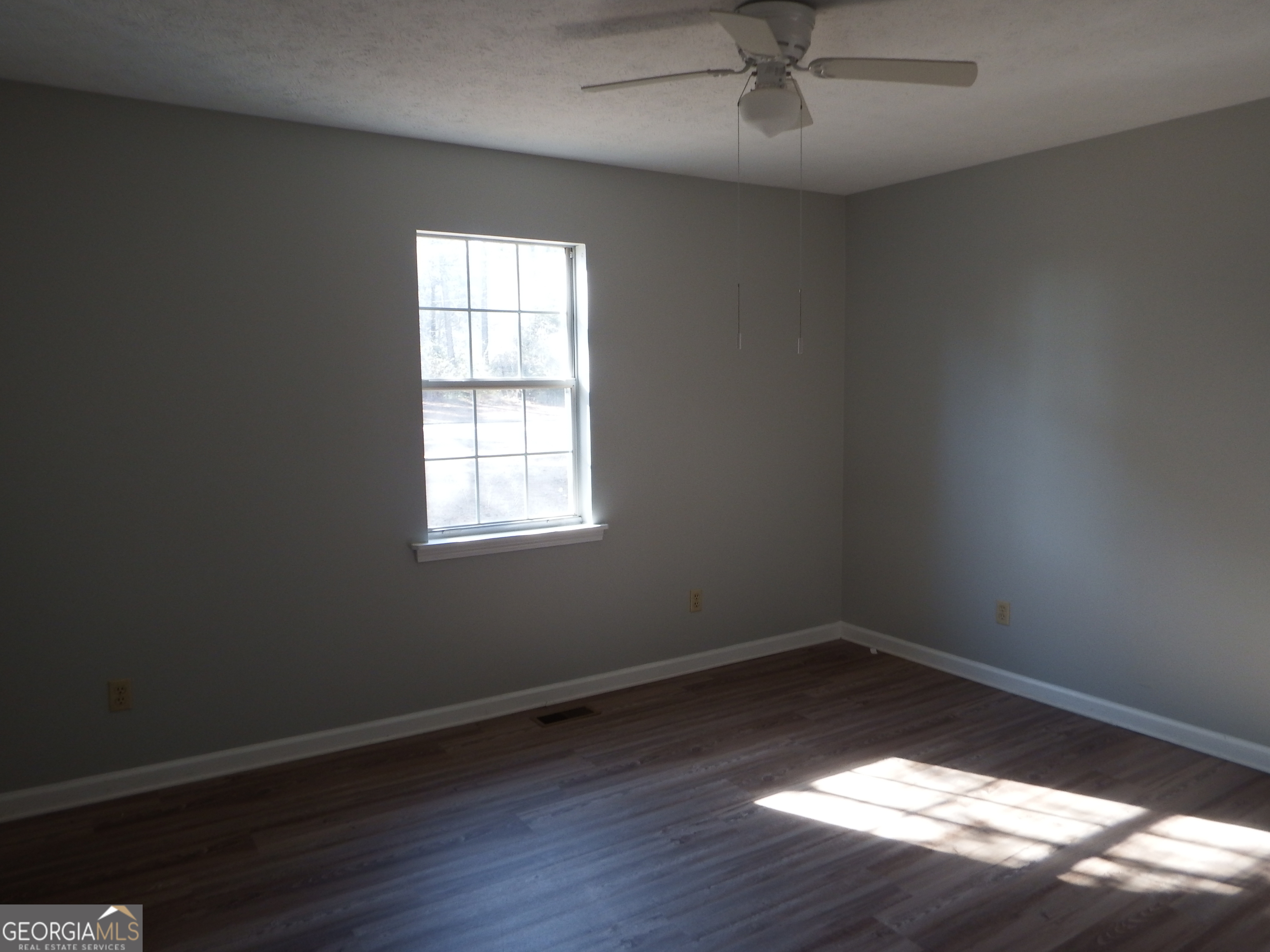 2780 Highpoint Road Snellville, GA 30078 - Photo 5 of 12 an empty room with wooden floor and windows