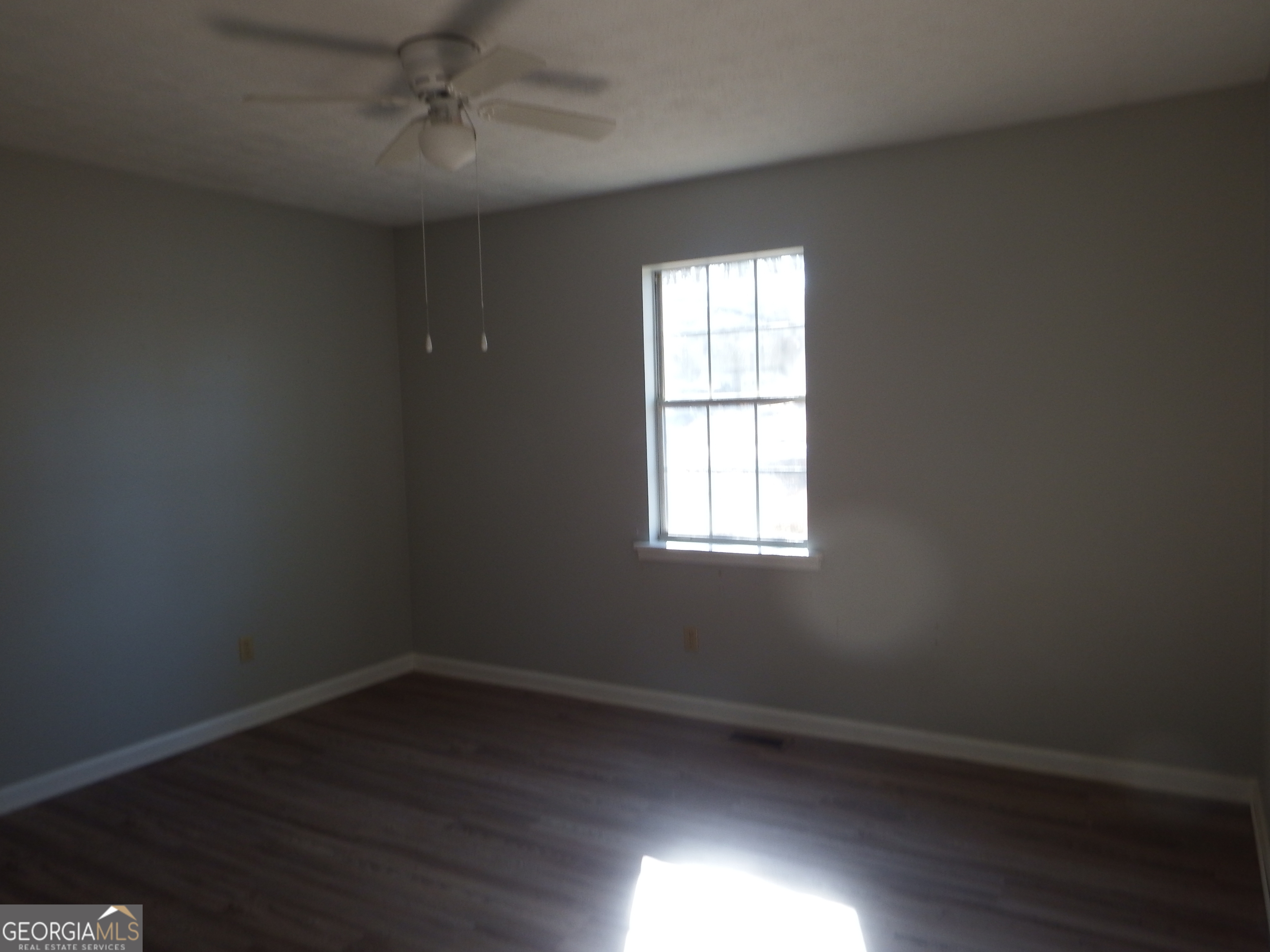 2780 Highpoint Road Snellville, GA 30078 - Photo 6 of 12 an empty room with wooden floor and windows
