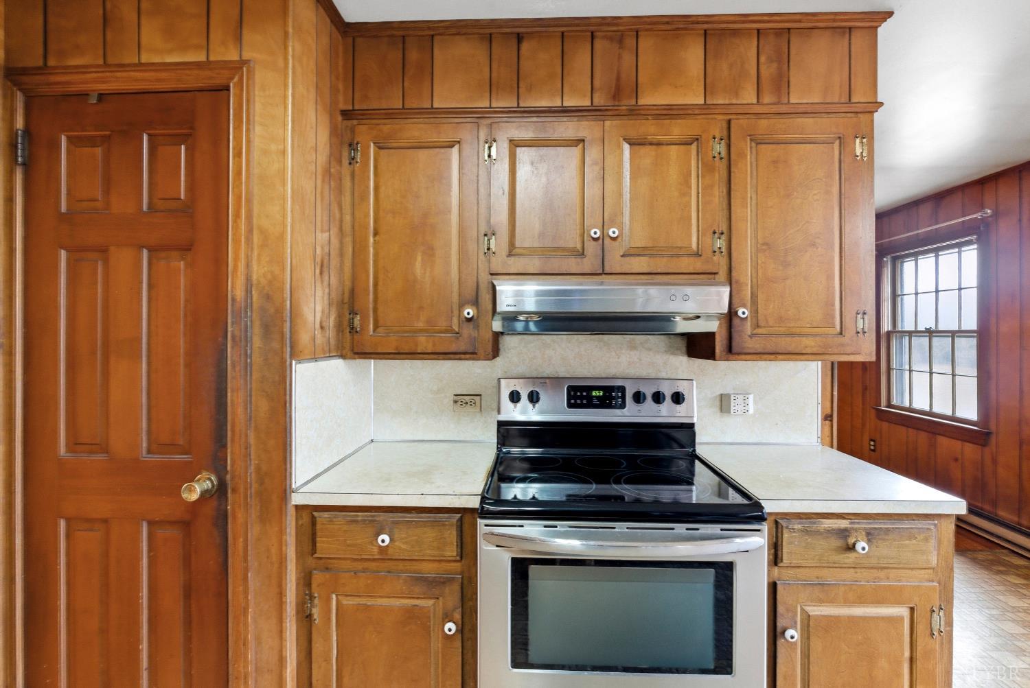 1730 Redfields Road Appomattox, VA 24522 - Photo 13 of 53 a kitchen with granite countertop wooden cabinets and a stove top oven