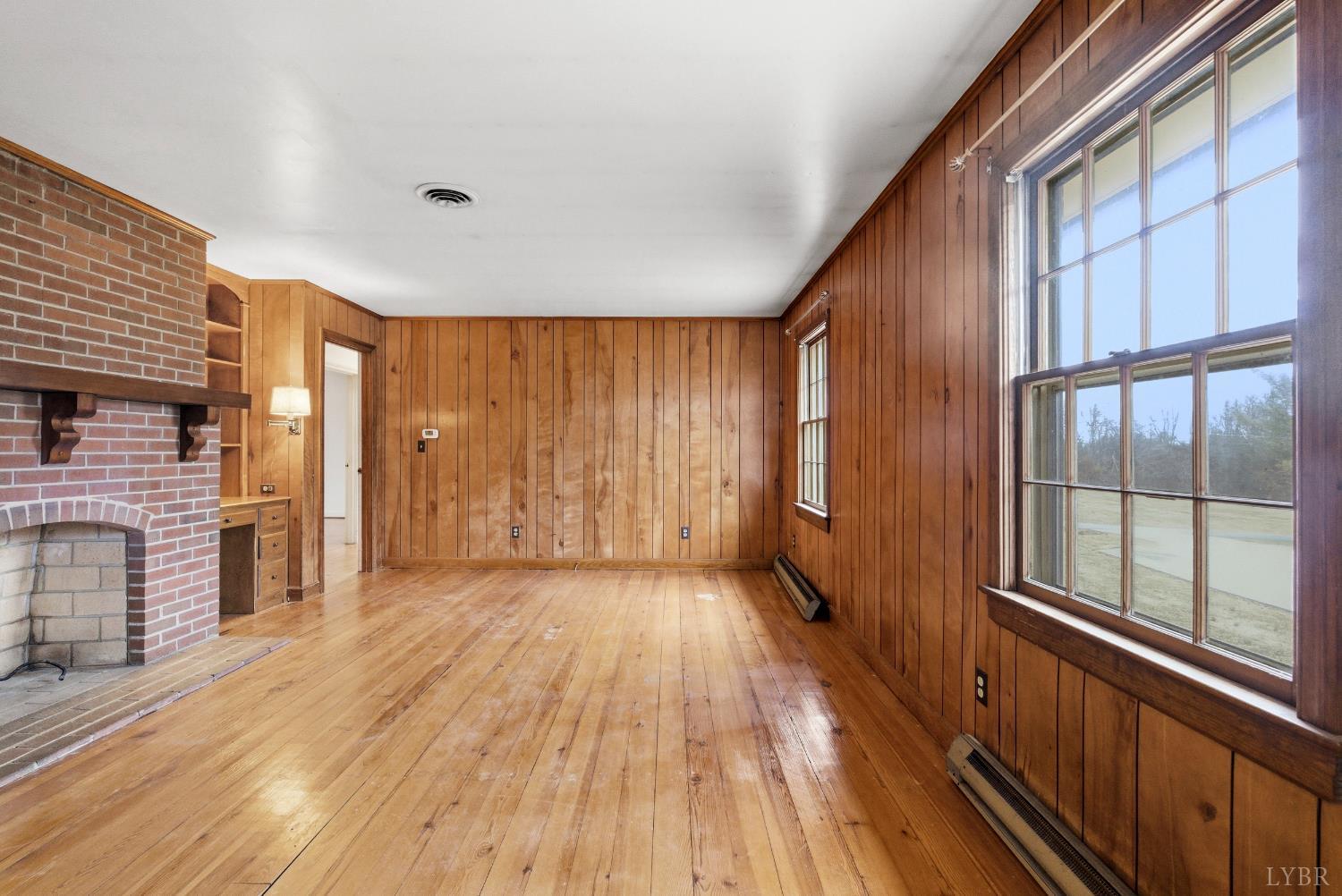 1730 Redfields Road Appomattox, VA 24522 - Photo 18 of 53 an empty room with wooden floor and windows
