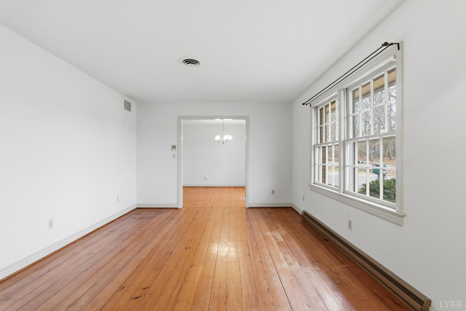 1730 Redfields Road Appomattox, VA 24522 - Photo 9 of 53 a view of an empty room with wooden floor and a window