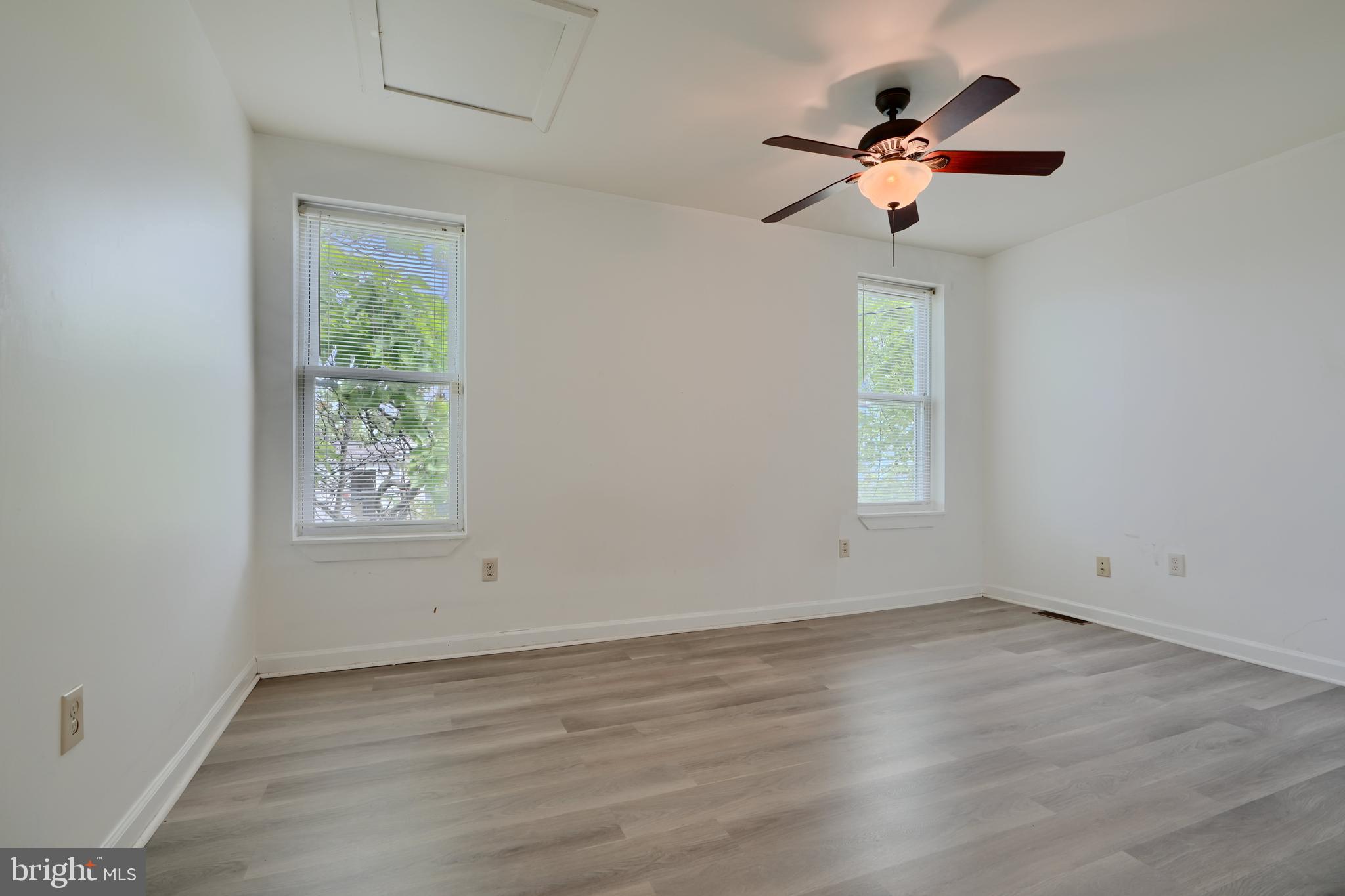 2251 Annapolis Road Baltimore, MD 21230 - Photo 12 of 13 an empty room with wooden floor fan and windows