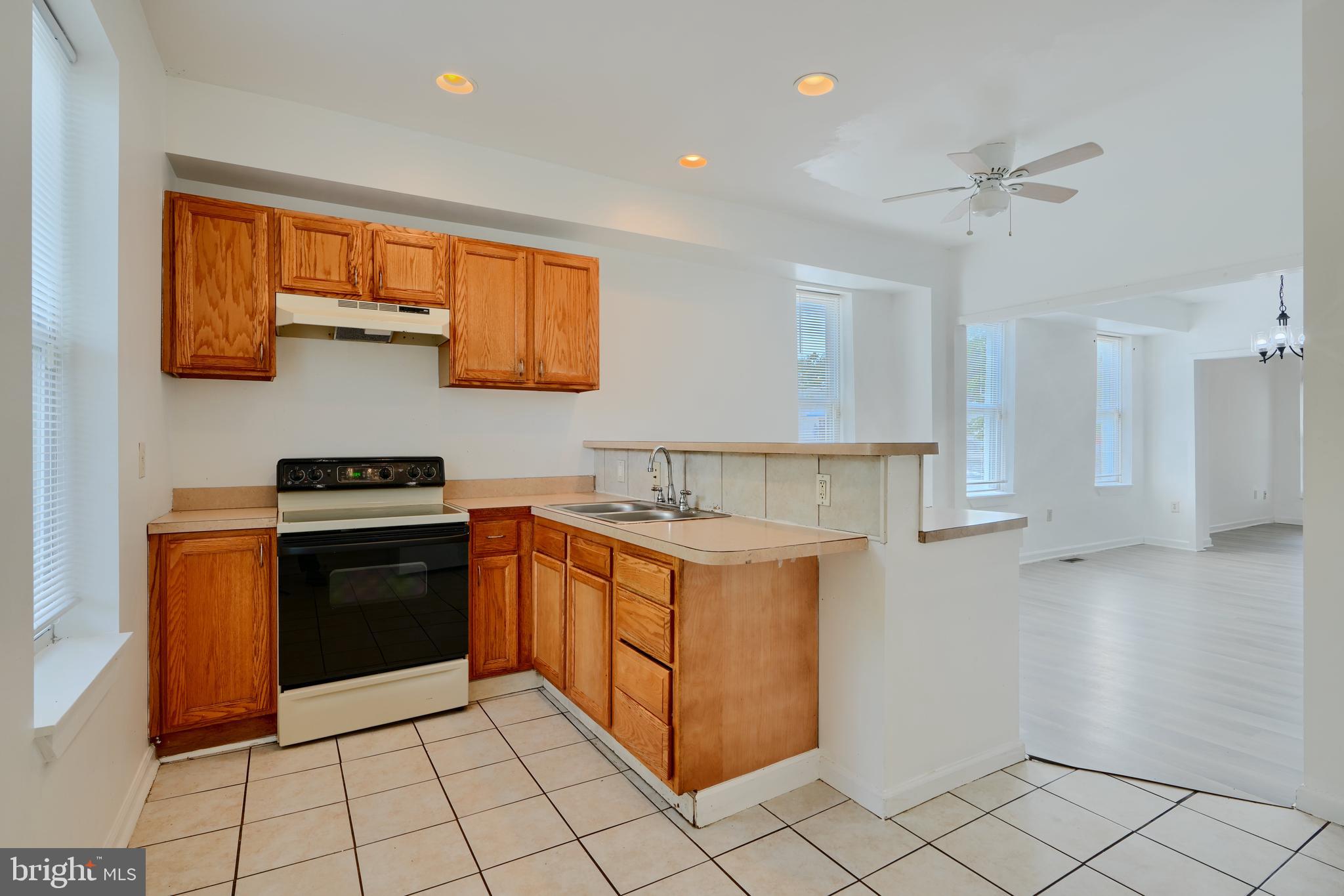 2251 Annapolis Road Baltimore, MD 21230 - Photo 6 of 13 a kitchen with stainless steel appliances granite countertop a stove a sink and a refrigerator