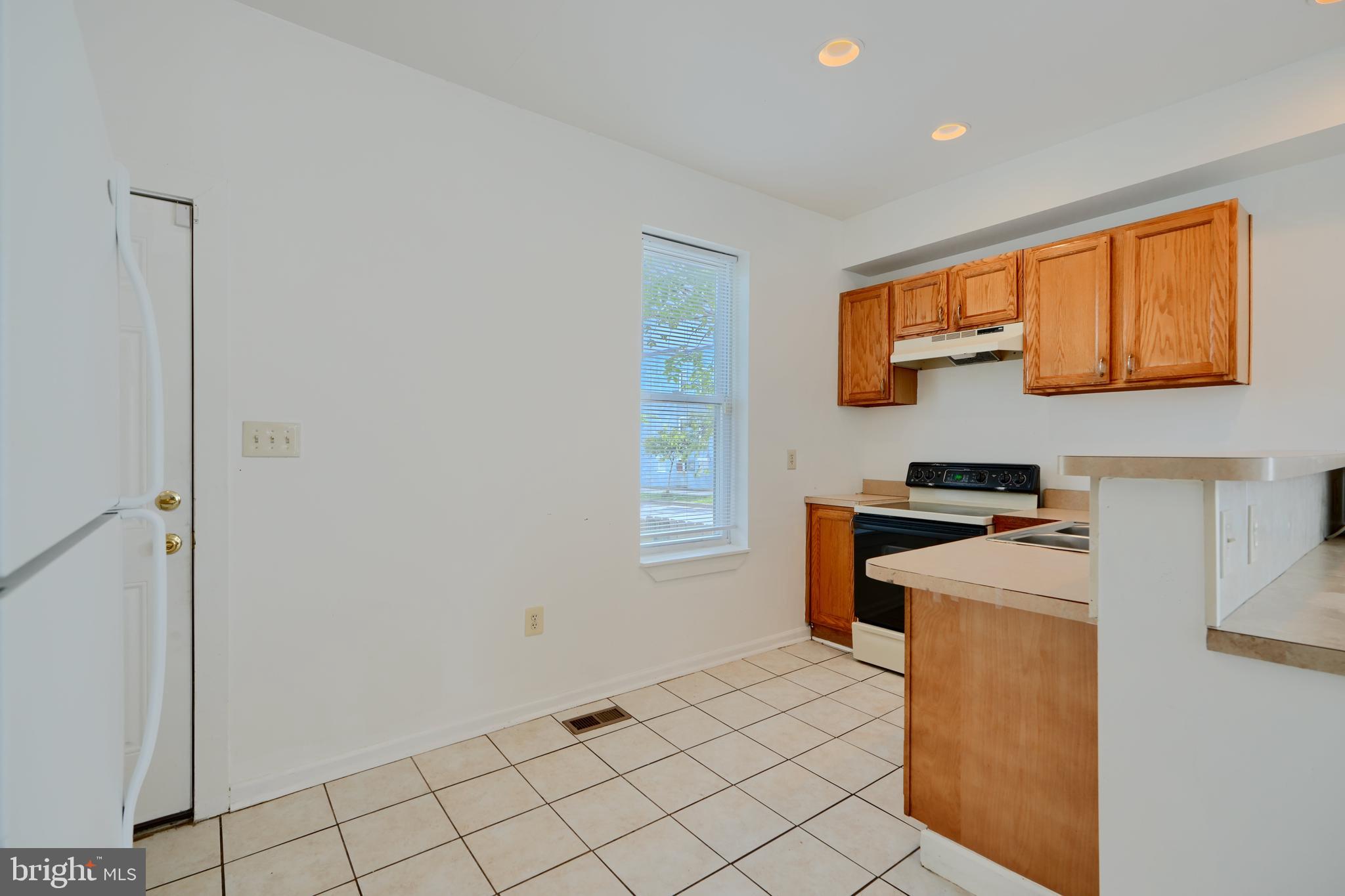 2251 Annapolis Road Baltimore, MD 21230 - Photo 7 of 13 a kitchen with stainless steel appliances granite countertop a stove a sink and a refrigerator