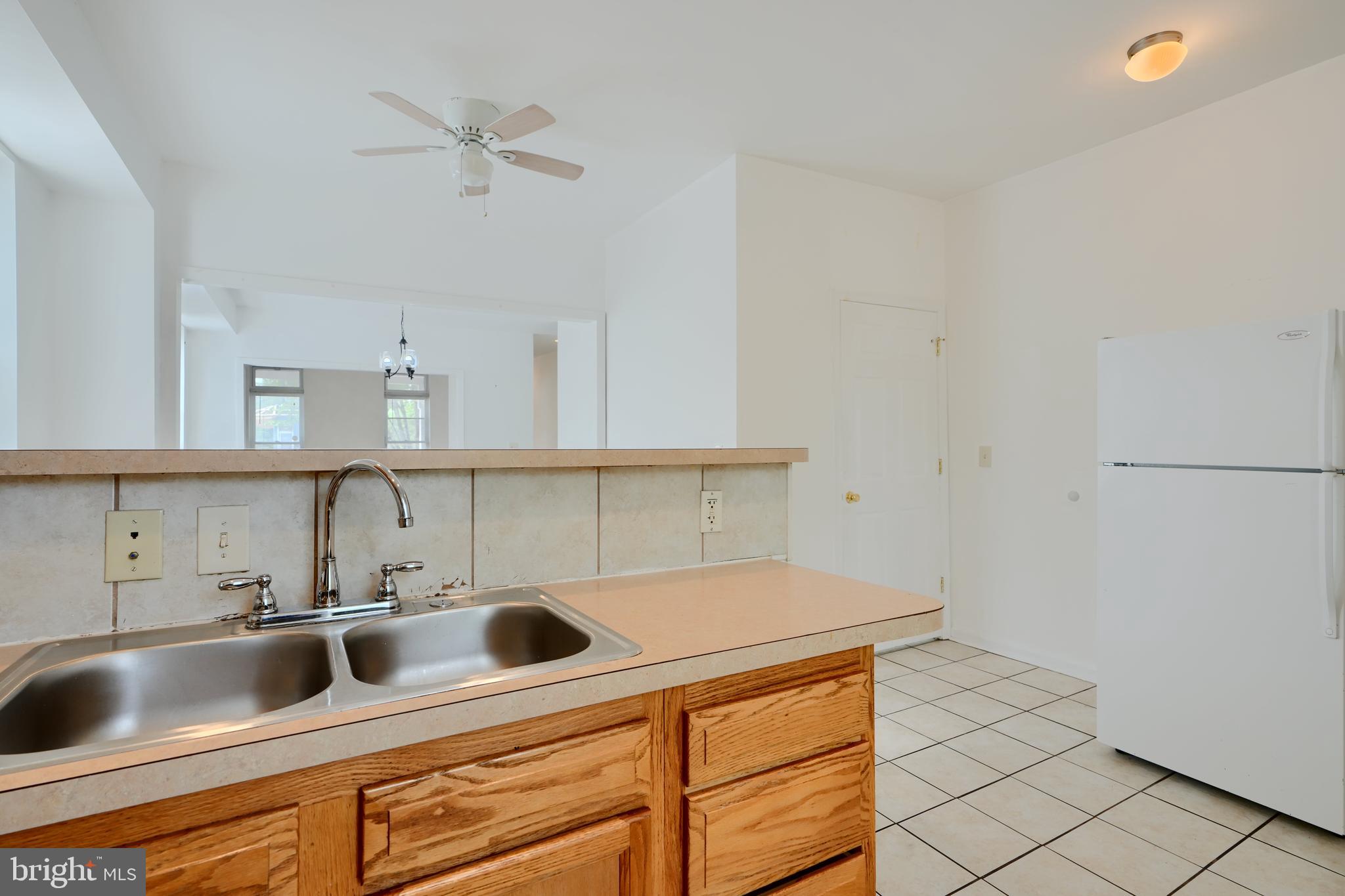 2251 Annapolis Road Baltimore, MD 21230 - Photo 8 of 13 a kitchen with cabinets a sink and a stove
