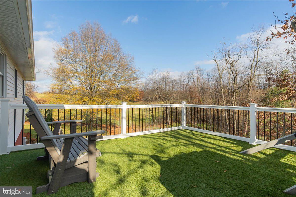 11701 Walnut Point Road Hagerstown, MD 21740 - Photo 16 of 56 a view of a patio with a table chairs and a floor to ceiling window