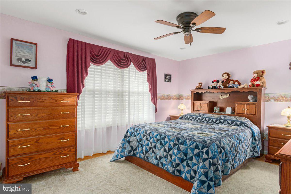 11701 Walnut Point Road Hagerstown, MD 21740 - Photo 25 of 56 a bedroom with a bed and a dresser