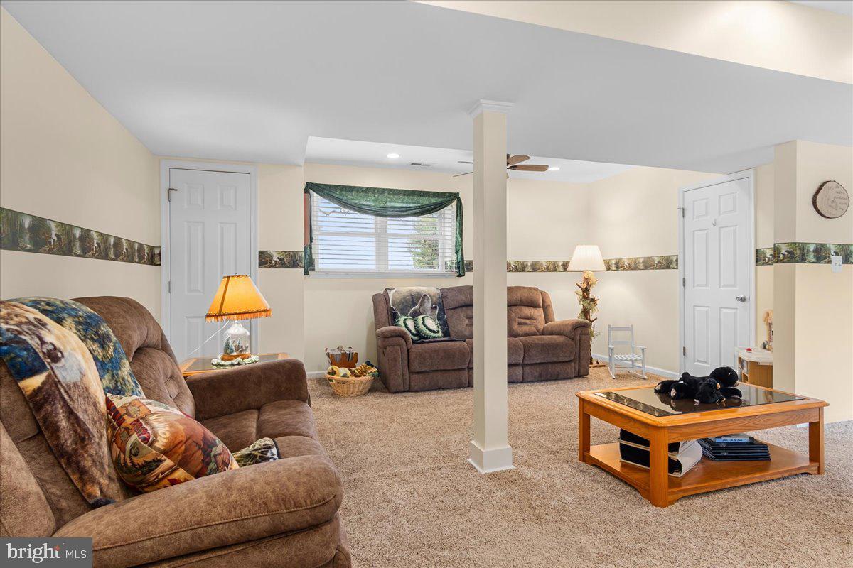 11701 Walnut Point Road Hagerstown, MD 21740 - Photo 30 of 56 a living room with furniture and a couch