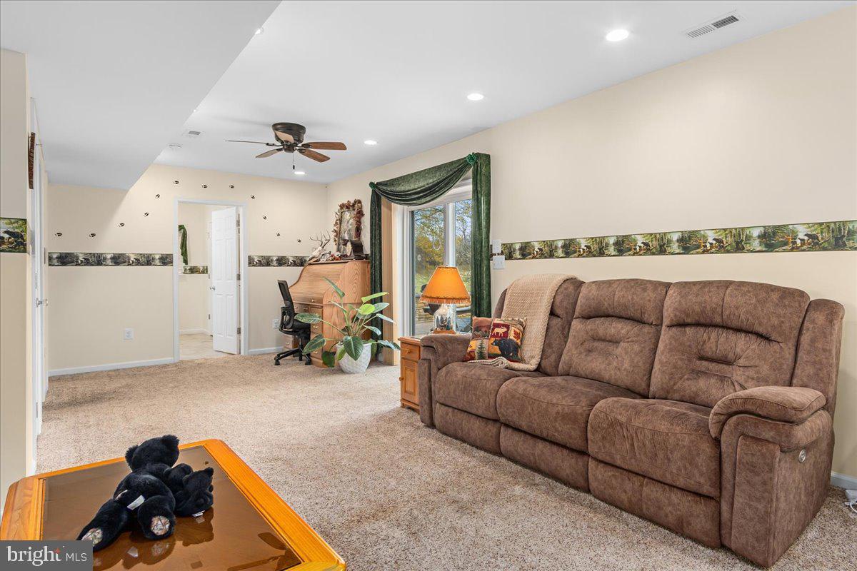 11701 Walnut Point Road Hagerstown, MD 21740 - Photo 31 of 56 a living room with furniture and a chandelier
