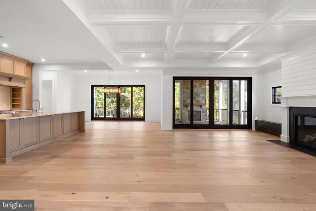 a view of an empty room with a fireplace and a window