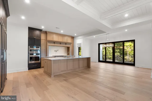 a view of an empty room with glass door and balcony