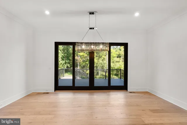a large white kitchen with a large window and stainless steel appliances