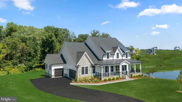 a front view of a house with a garden and plants