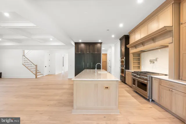 a large white kitchen with a stove a sink and a refrigerator