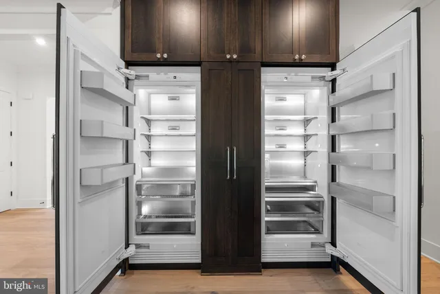 a view of walk in closet with empty racks