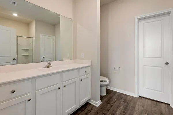 a bathroom with a double vanity sink and a toilet