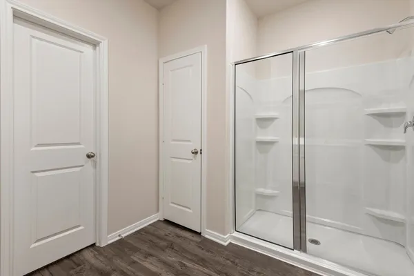 a bathroom with a glass shower door