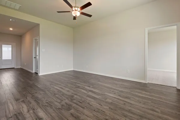 a view of a room with wooden floor and white walls