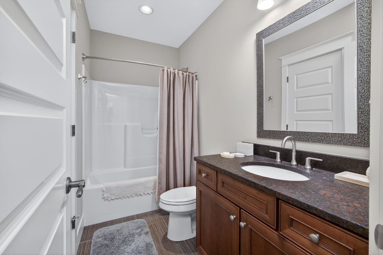 5700 Emily Road Bettendorf, IA 52722 - Photo 46 of 58 a bathroom with a granite countertop sink toilet and shower