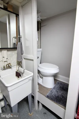 a bathroom with a sink toilet and mirror