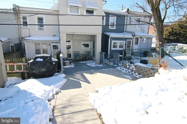 a view of a building with a bench in front of house