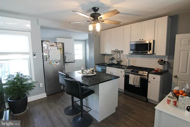 a kitchen with a sink appliances and cabinets