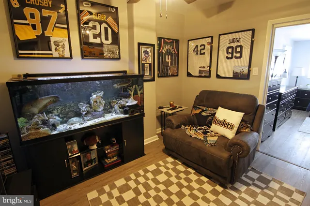 a living room with furniture and painting on the wall