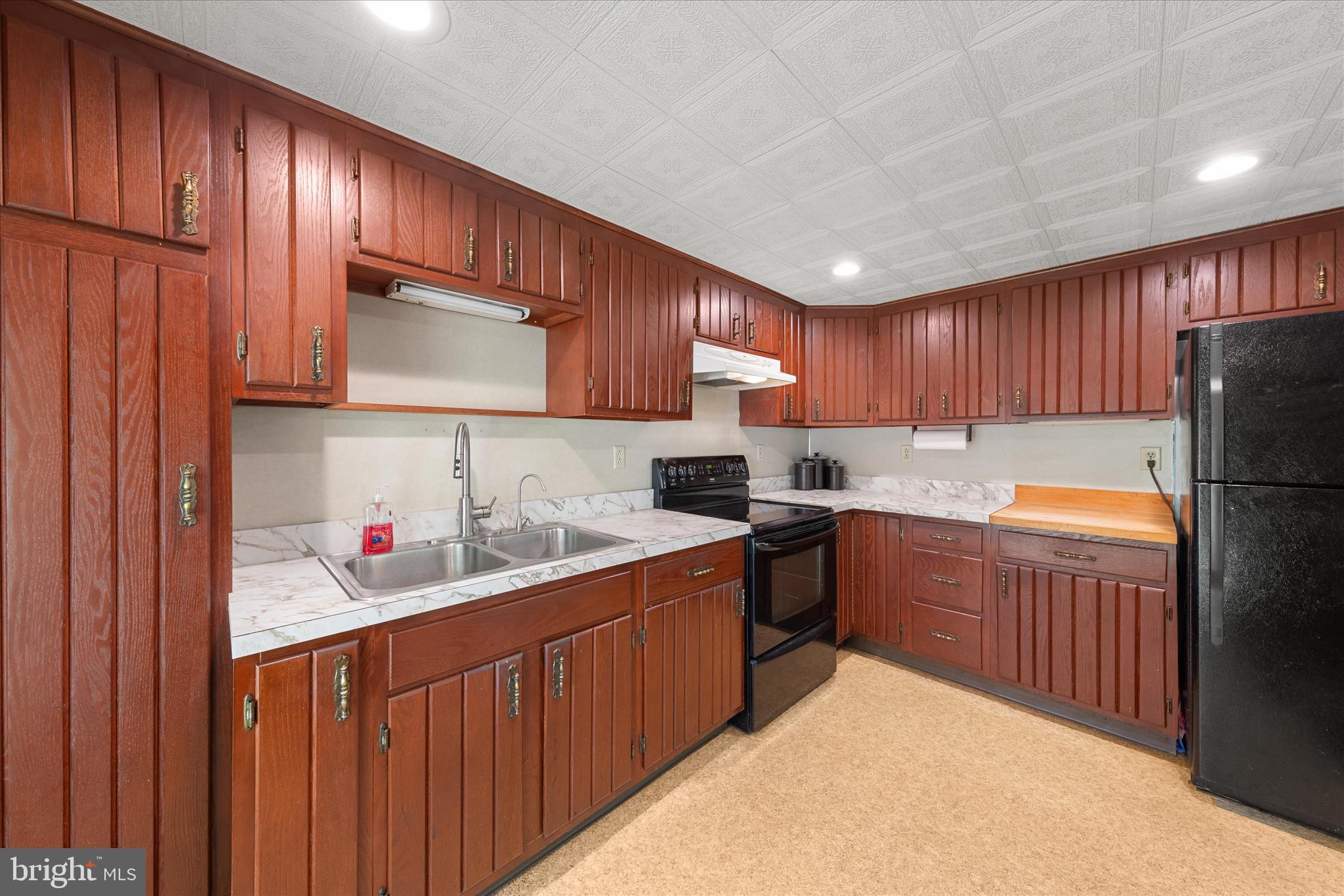 251 Rings End Road Millington, MD 21651 - Photo 7 of 47 a kitchen with stainless steel appliances granite countertop wooden cabinets a stove top oven a sink and dishwasher