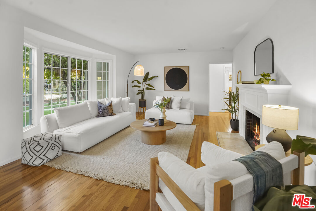 10129 Plainview Avenue Tujunga, CA 91042 - Photo 11 of 51 a living room with furniture and a fireplace