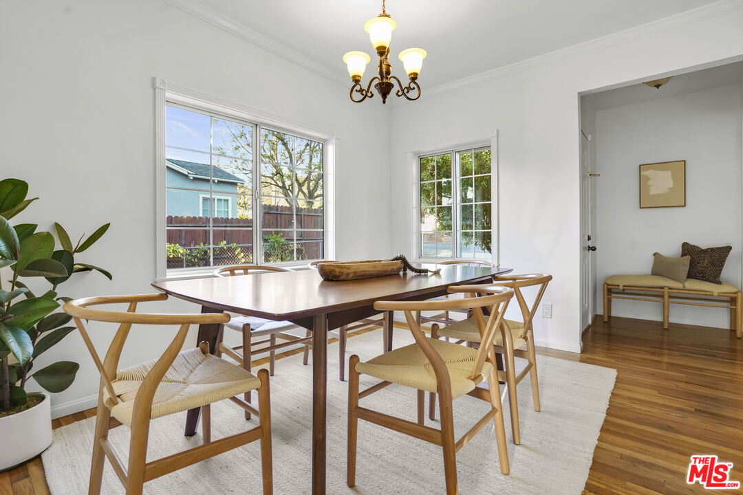 10129 Plainview Avenue Tujunga, CA 91042 - Photo 12 of 51 a view of a dining room with furniture a chandelier and wooden floor