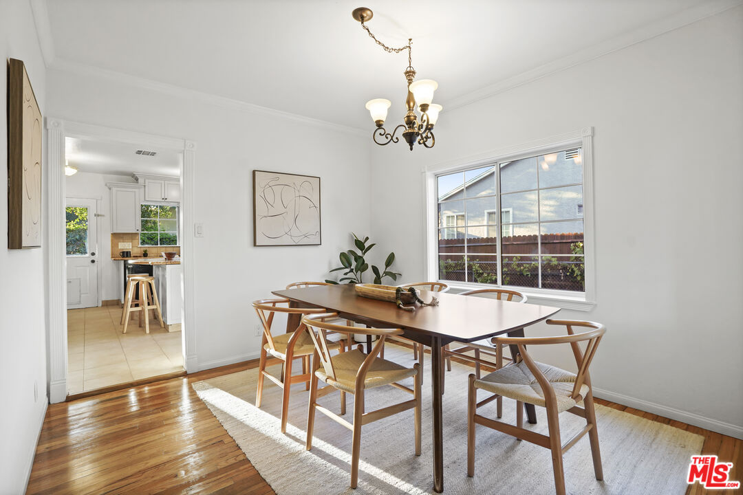 10129 Plainview Avenue Tujunga, CA 91042 - Photo 14 of 51 a view of a dining room with furniture wooden floor and a chandelier