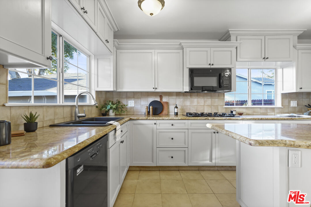 10129 Plainview Avenue Tujunga, CA 91042 - Photo 18 of 51 a kitchen with a sink stove and cabinets
