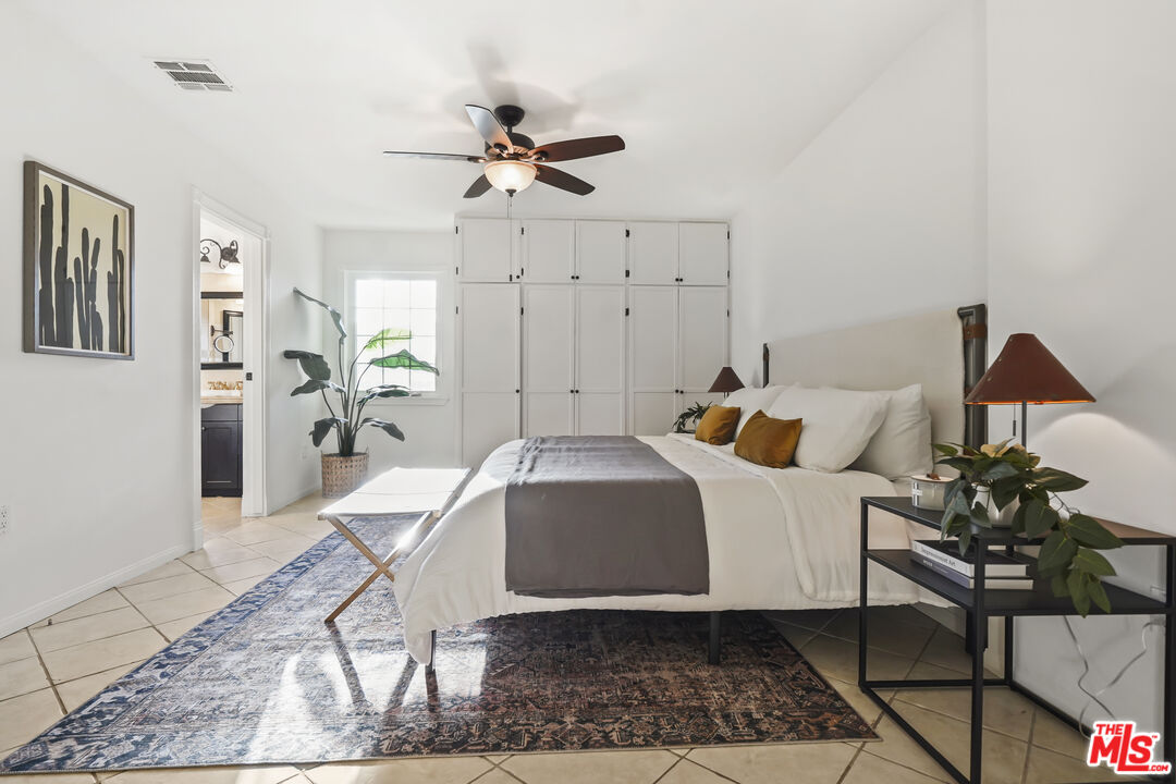 10129 Plainview Avenue Tujunga, CA 91042 - Photo 21 of 51 a spacious bedroom that has a bed and a chair in it