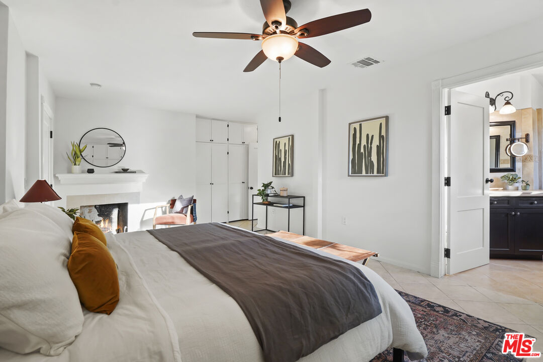 10129 Plainview Avenue Tujunga, CA 91042 - Photo 22 of 51 a bedroom with a bed and a chandelier