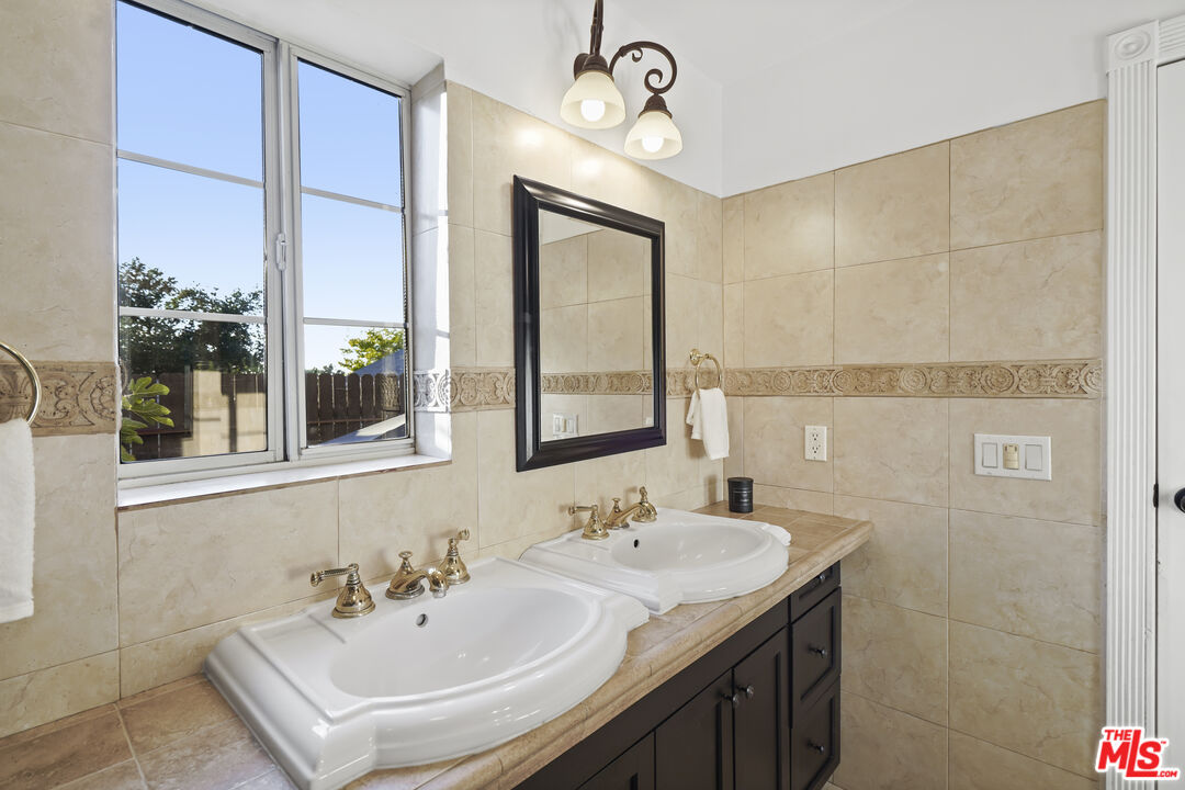 10129 Plainview Avenue Tujunga, CA 91042 - Photo 26 of 51 a bathroom with a sink and a mirror