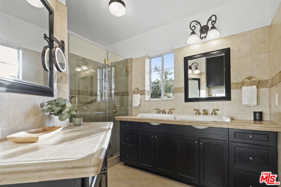 10129 Plainview Avenue Tujunga, CA 91042 - Photo 27 of 51 a bathroom with a double vanity sink mirror and double