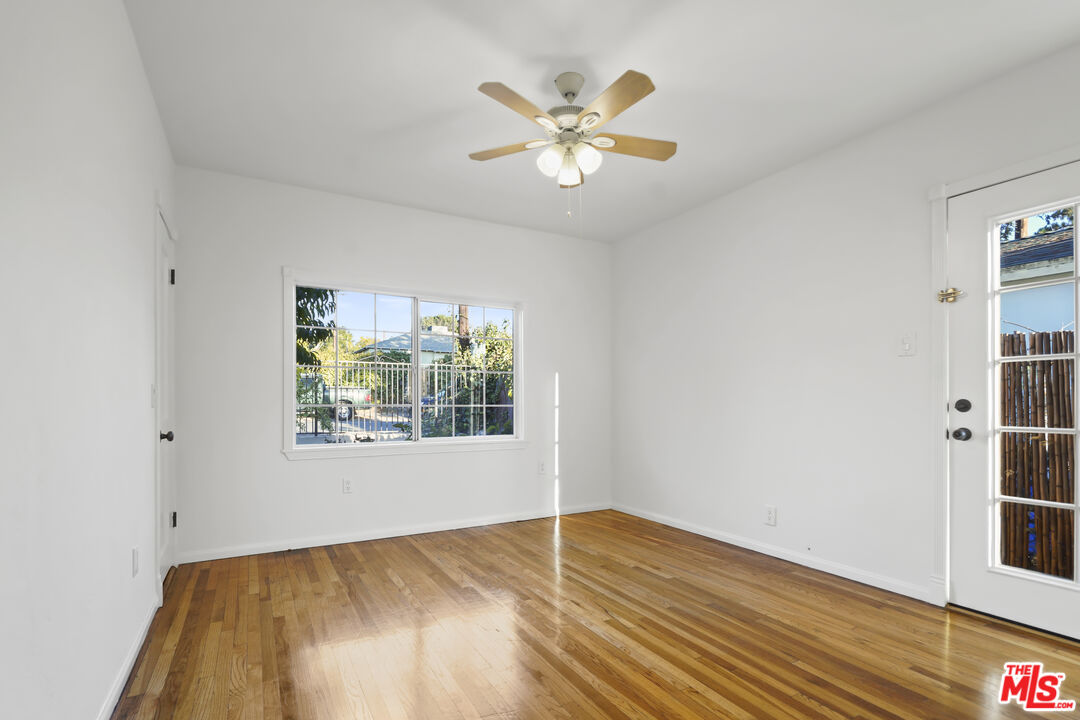 10129 Plainview Avenue Tujunga, CA 91042 - Photo 30 of 51 a view of an empty room with wooden floor and a window