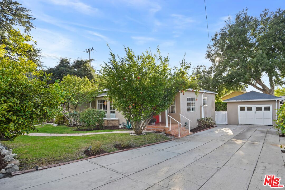 10129 Plainview Avenue Tujunga, CA 91042 - Photo 3 of 51 a front view of a house with garden