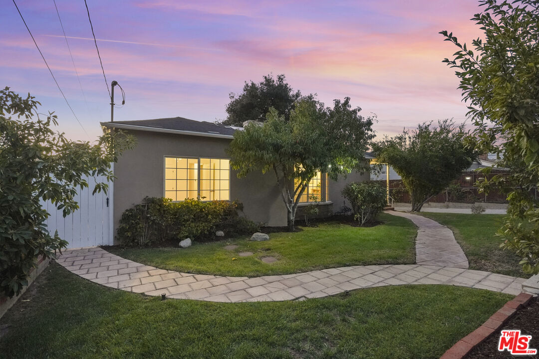 10129 Plainview Avenue Tujunga, CA 91042 - Photo 39 of 51 a view of a house with a big yard and potted plants
