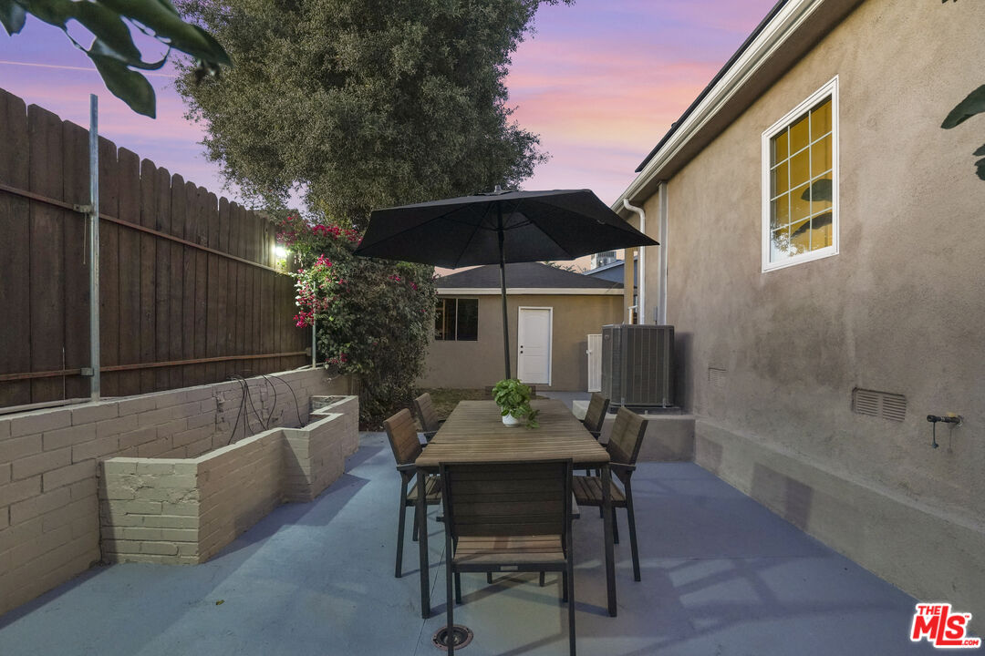 10129 Plainview Avenue Tujunga, CA 91042 - Photo 45 of 51 a view of a patio with table and chairs and potted plants