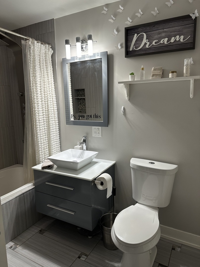 9830 Sayre Avenue, Unit 13 Chicago Ridge, IL 60415 - Photo 28 of 34 a bathroom with a toilet sink and mirror