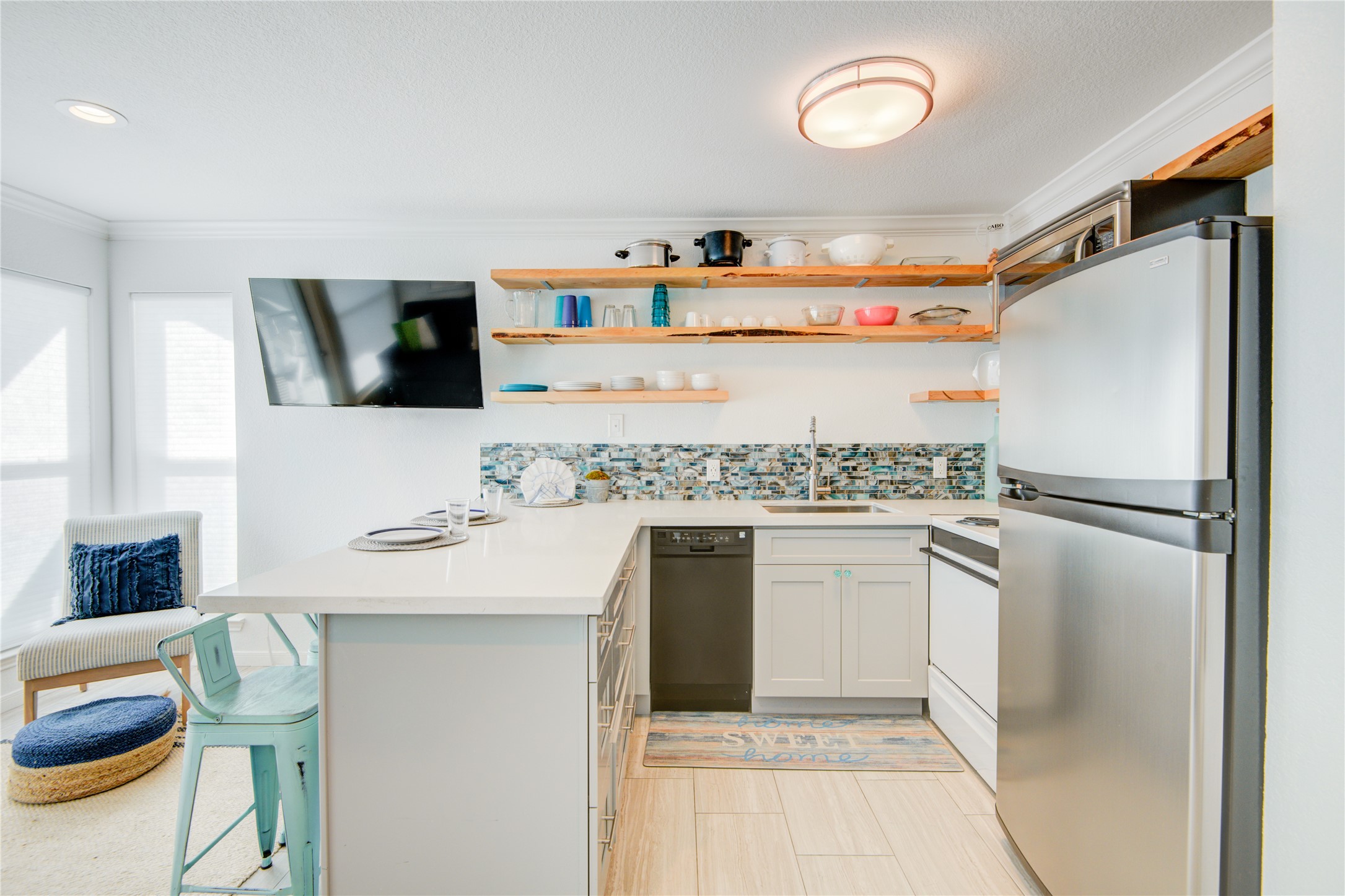 10811 Termini-San Luis Pass Road, Unit 2307 Galveston, TX 77554 - Photo 11 of 32 a kitchen with stainless steel appliances granite countertop a refrigerator and a stove