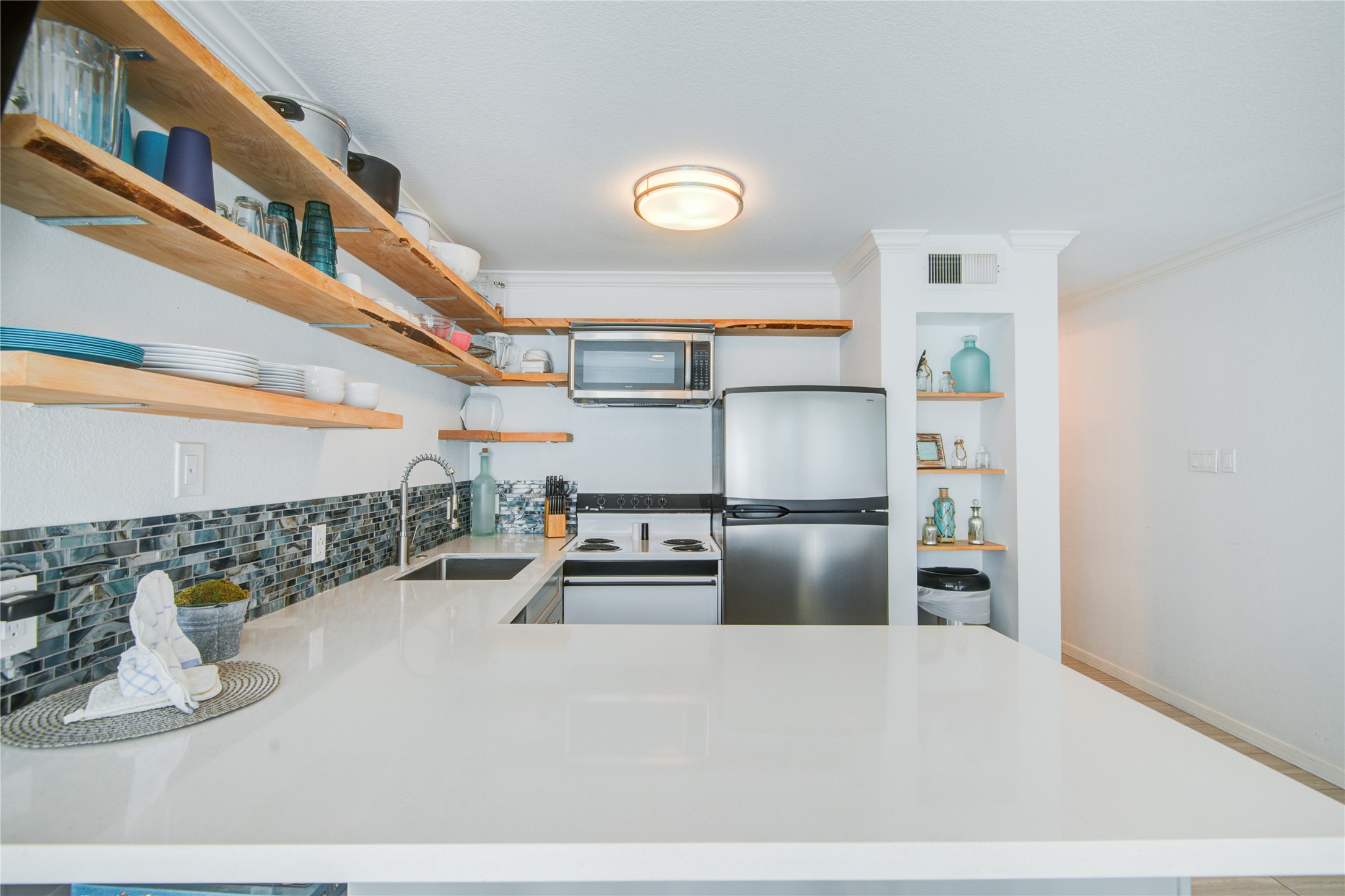 10811 Termini-San Luis Pass Road, Unit 2307 Galveston, TX 77554 - Photo 12 of 32 a kitchen with refrigerator and window