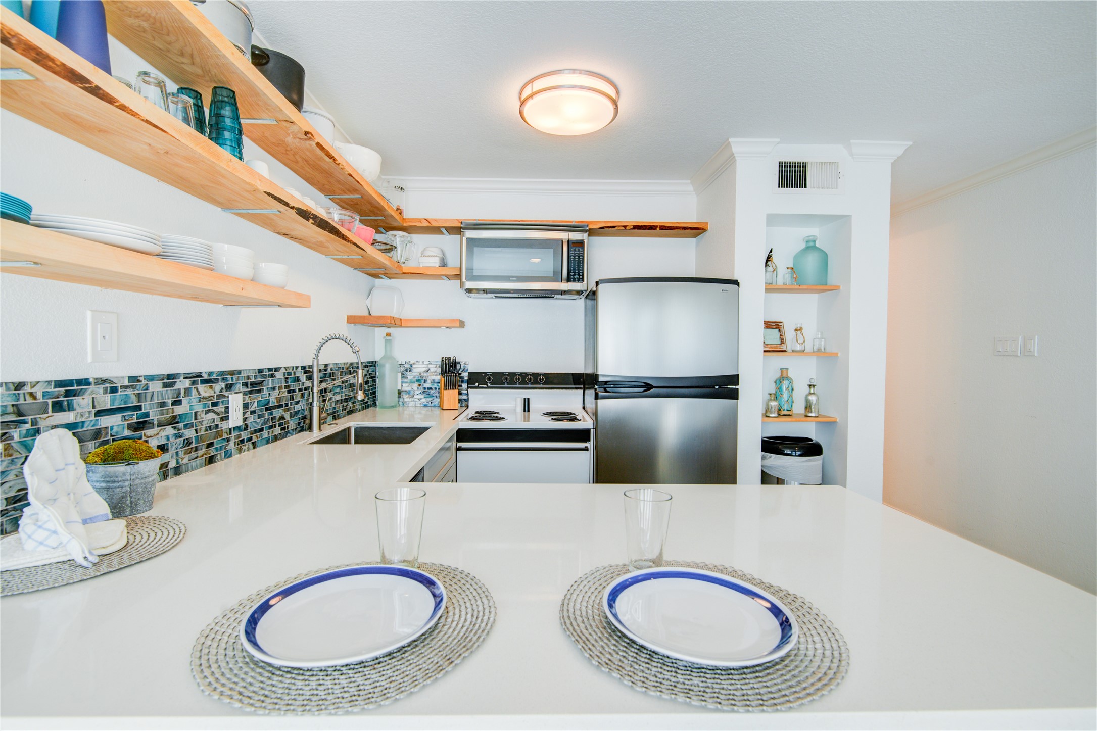 10811 Termini-San Luis Pass Road, Unit 2307 Galveston, TX 77554 - Photo 13 of 32 a kitchen with a sink and a stove